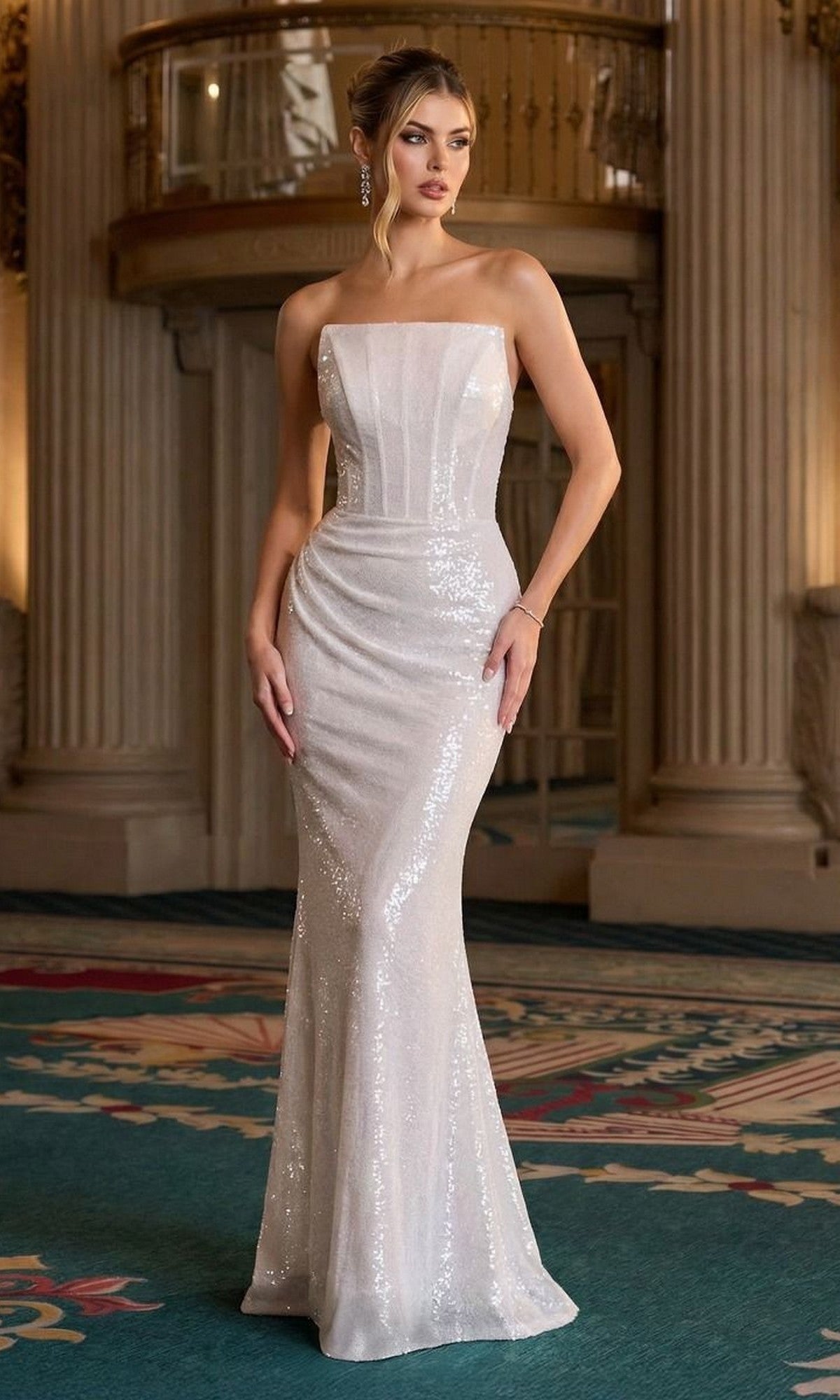 A woman in an off-white, strapless sequined Long Prom Dress—Ladivine J904—stands in a grand, ornate room with columns and a patterned carpet.